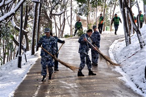 玉峰山上军民除雪保安全